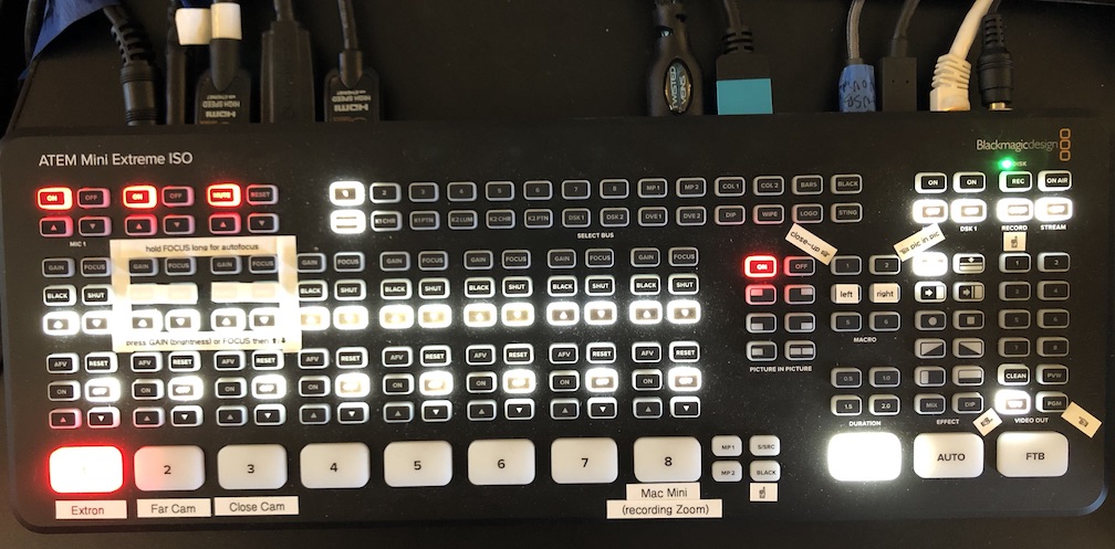Photograph of ATEM video switcher with certain buttons lit up to show the current selections, e.g., video source #1 “Extron” (now Kramer). The labels are easier to read in the other photo.