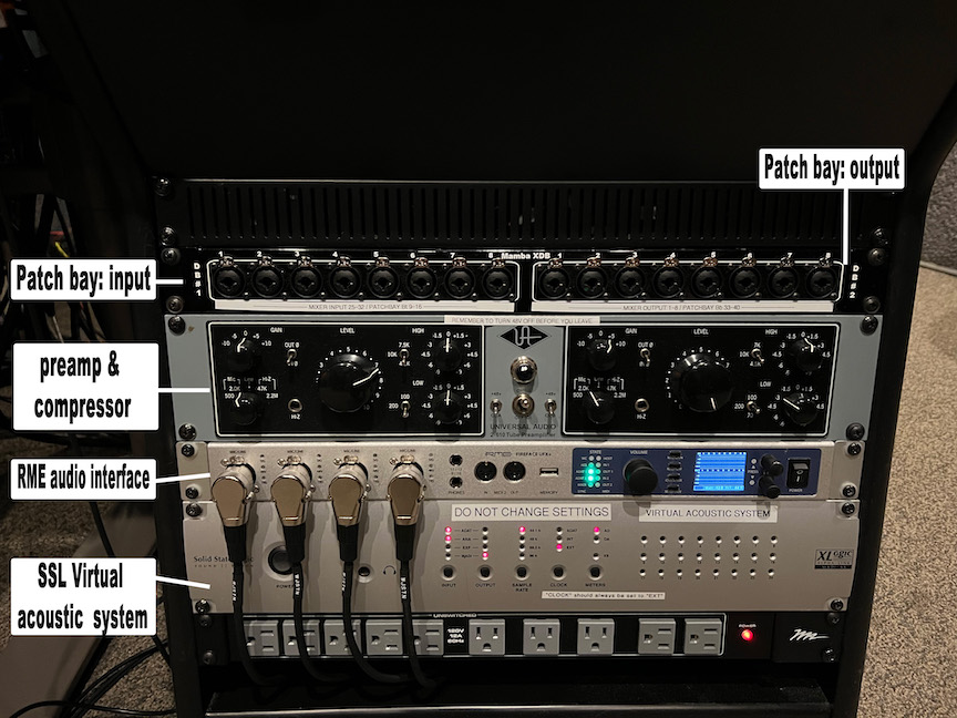 Lower portion of the same rack, showing some XLR/7mm jacks and a UA 2-610 tube preamp (accessible via the patch bay) as well as the CAVIAR audio interfaces and some user-accessible AC power outlets.