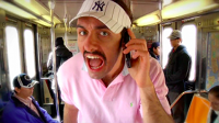 male wearing New York Yankees visor singing unabashedly into his phone on the subway